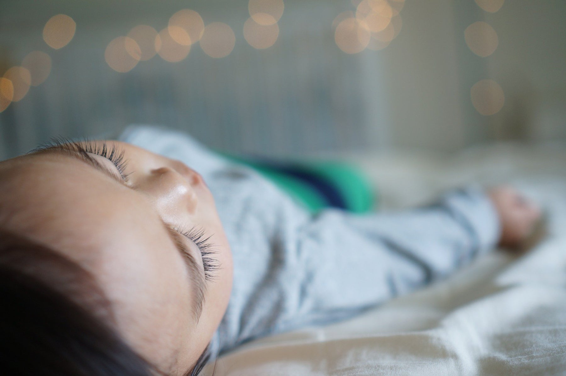 Brunette woman dressed in white sleeping