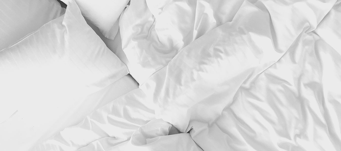 White quilt over white bed