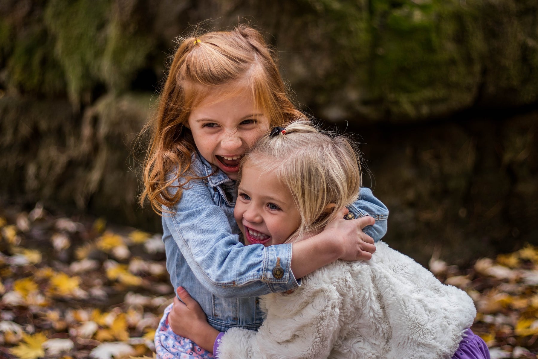 Two girls hugging and laughing