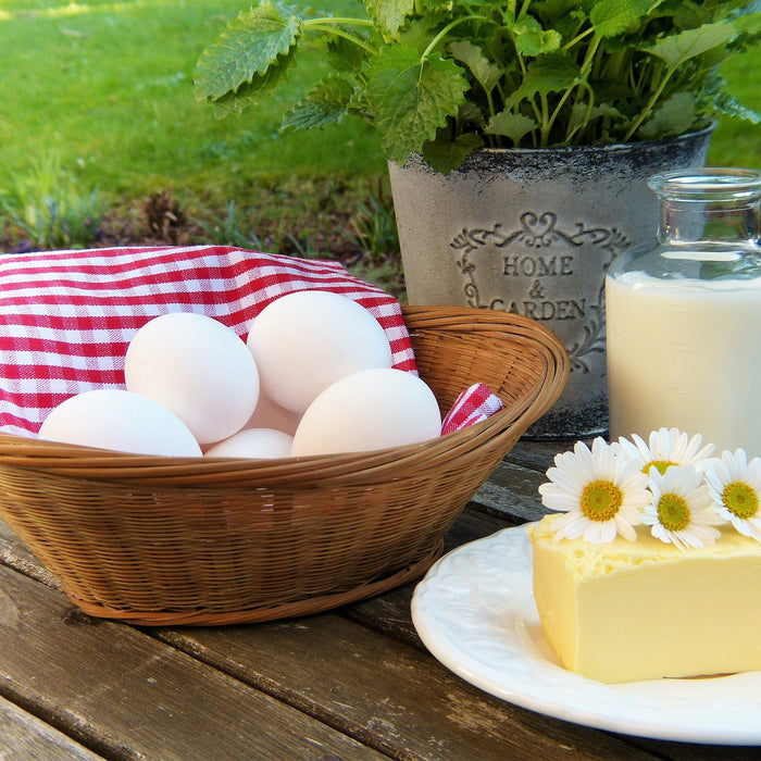 Eggs, cheese and milk on a wooden table