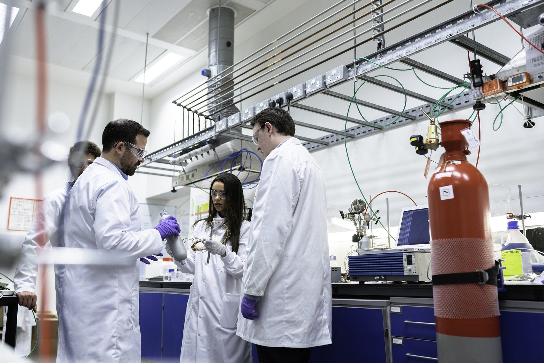 People dressed in white in a laboratory