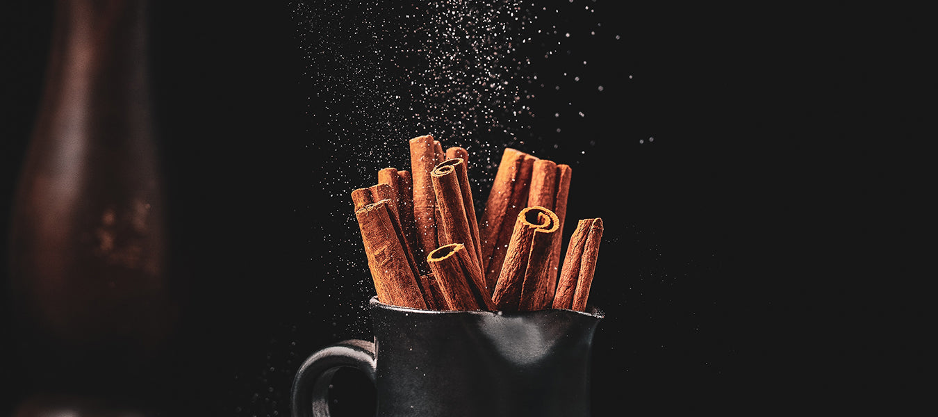 Cinnamon in a cup on a black background