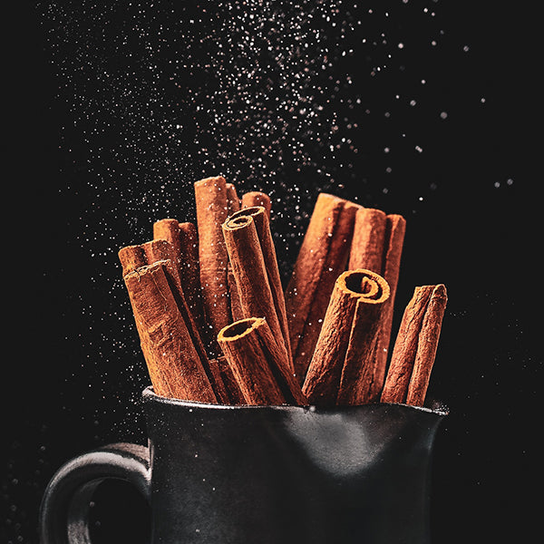 Cinnamon in a cup on a black background
