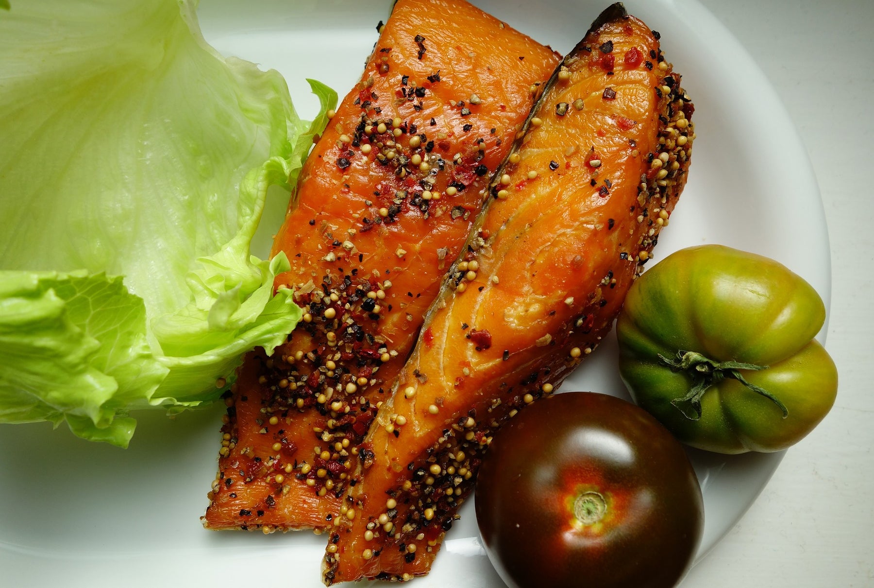 Salmon with salad and tomatoes on a plate