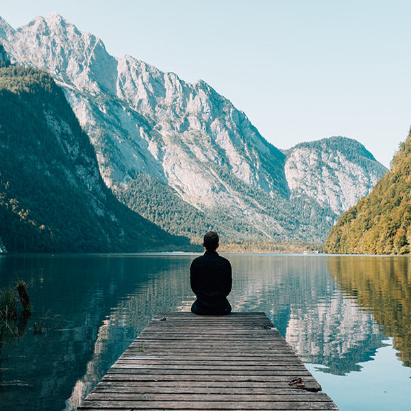 A man meditating in the mountains