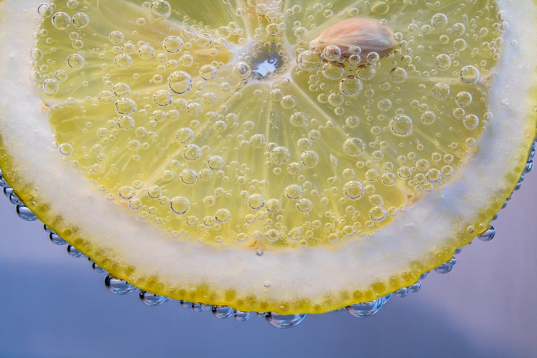 Drops of water poring down a slice of lemon